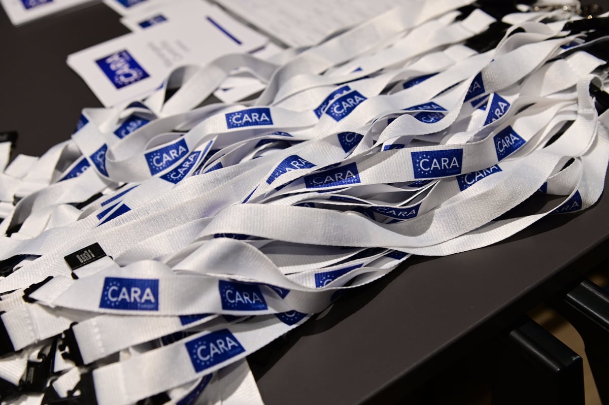 CARA Badges presented on a table to show their digital annual assembly hosted on-site